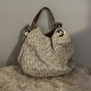 Michael Kors tote with brown purse handles gold emblem
